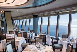 Elegant dining area with panoramic sea views and guests enjoying their meals | MSC Cruises