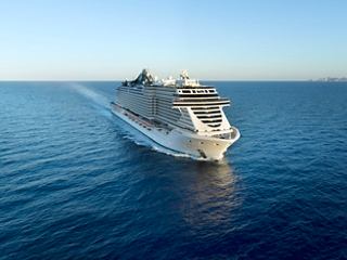 Aerial view of the MSC Seashore sailing smoothly across the calm sea under a clear sky | MSC Cruises