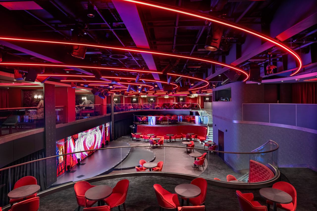 A vibrant bar lounge featuring modern decor and lighting, perfect for socialising and entertainment | MSC Cruises