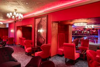 A vibrant lounge area featuring red decor and comfortable seating for relaxation and entertainment | MSC Cruises