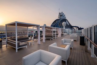 A spacious sun deck bar with comfortable seating, perfect for relaxation while enjoying stunning views | MSC Cruises