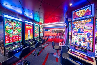 The vibrant MSC Signature Casino features an array of slot machines inviting guests to enjoy thrilling entertainment | MSC Cruises
