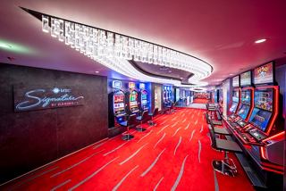 A vibrant casino area on MSC Seashore featuring bright lights and inviting slot machines | MSC Cruises