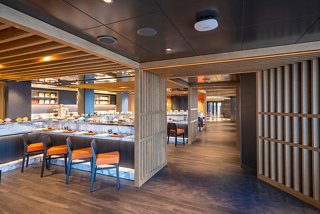 A welcoming view of the Kaito Sushi Bar, featuring modern seating and a warm atmosphere for dining | MSC Cruises