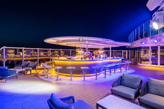 A vibrant outdoor bar area on MSC Seashore, perfect for evening gatherings and socialising under the stars | MSC Cruises