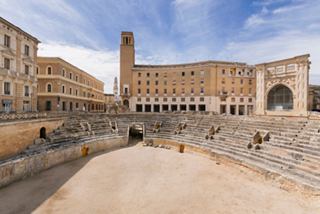 The ancient amphitheatre in Lecce, surrounded by historic buildings, invites exploration and cultural discovery | MSC Cruises