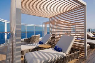 Relax in a luxurious cabana with sunbeds overlooking the serene sea on the MSC Yacht Club Sundeck | MSC Cruises