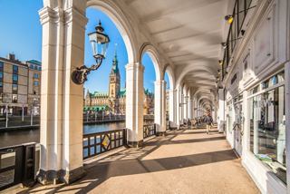 A scenic view of Alsterarkaden in Hamburg, showcasing its elegant architecture and inviting walkway along the water | MSC Cruises