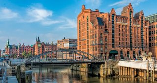 A scenic view of historic architecture near the waterfront in Hamburg, Germany, highlighting its rich maritime heritage | MSC Cruises