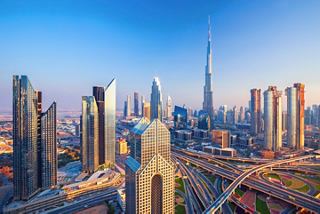 Panoramic view of Dubai featuring skyscrapers under a vibrant sky | MSC Cruises
