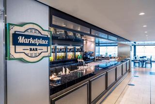 A welcoming view of the Marketplace Buffet with a stylish bar and inviting seating area | MSC Cruises