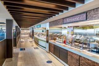 A spacious buffet area on MSC Virtuosa featuring various food displays and inviting seating options | MSC Cruises
