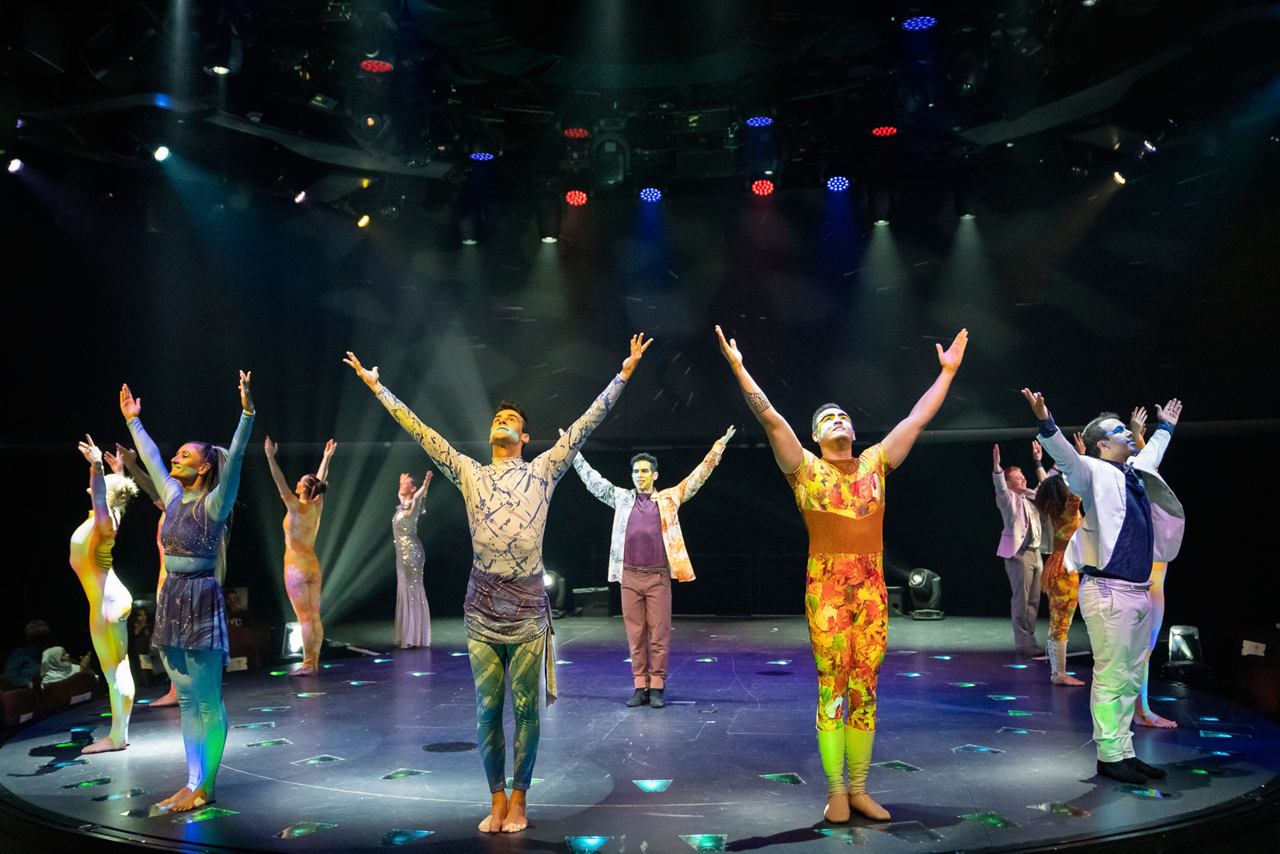 A vibrant stage performance with diverse dancers celebrating creativity and joy in a lively atmosphere | MSC Cruises