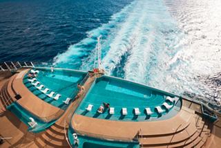 A couple enjoys the stunning infinity pool on the MSC Seashore, with waves gently crashing beside them | MSC Cruises