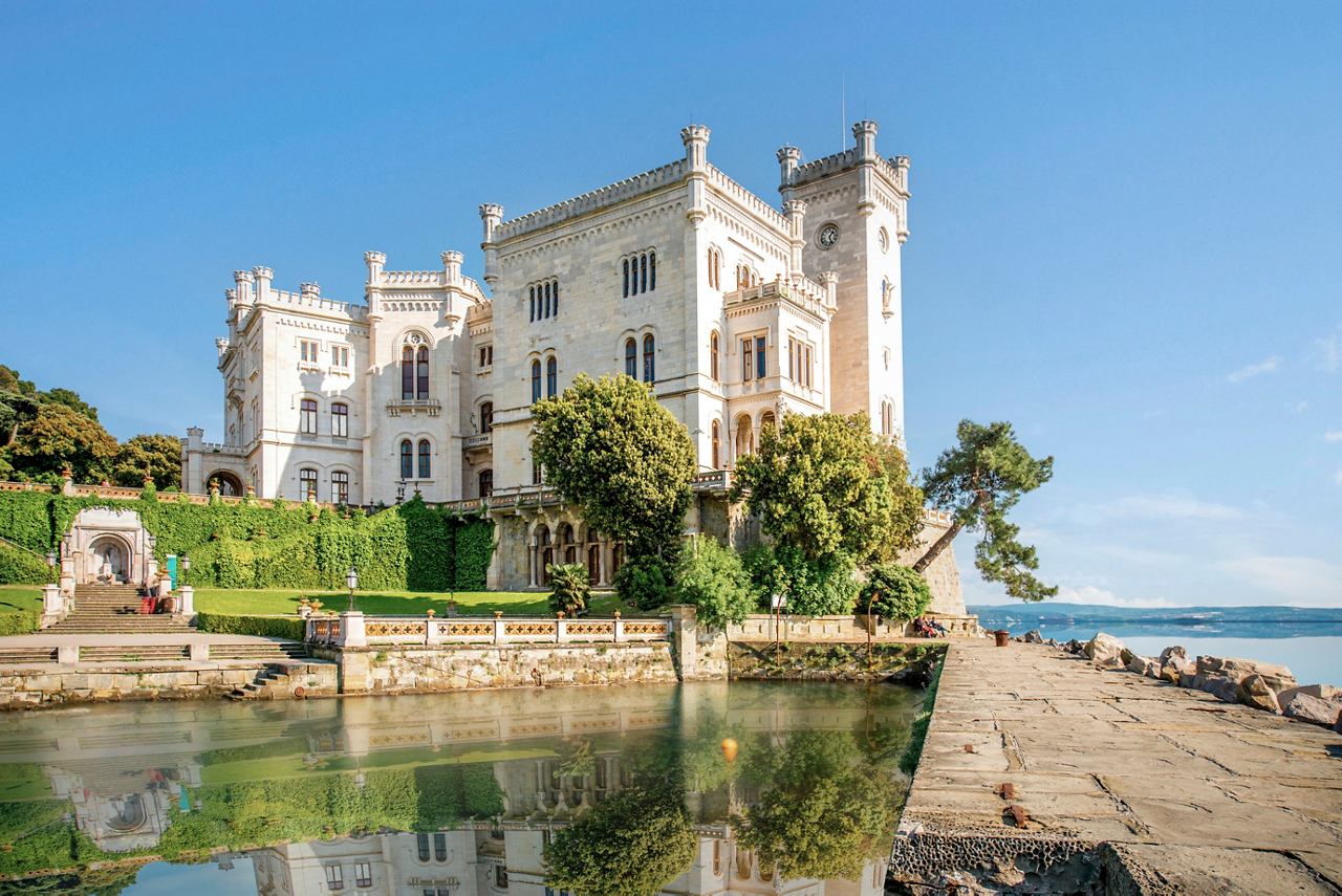 Miramare Castle with lush greenery and tranquil waters, inviting exploration in Trieste, Italy | MSC Cruises