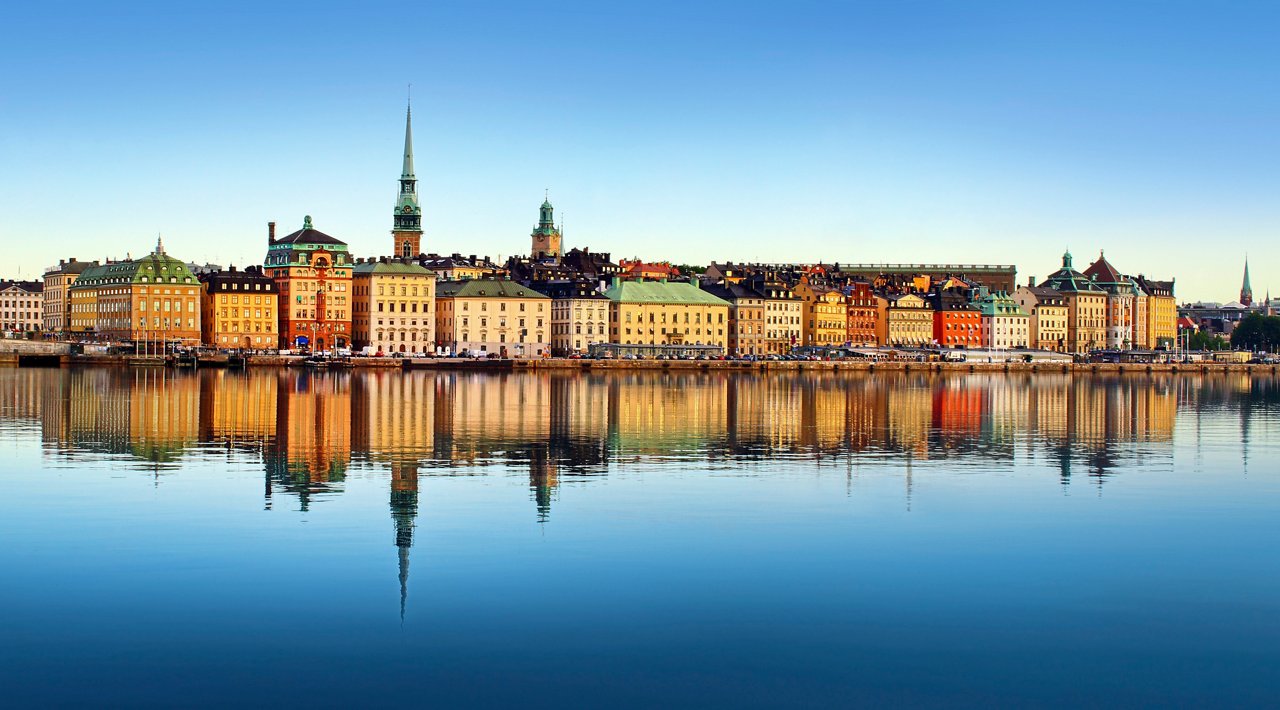 A stunning view of Stockholm's skyline reflecting on the calm sea, showcasing the charm of Gamla Stan and its historic towers | MSC Cruises