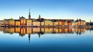A stunning view of Stockholm's skyline reflecting on the calm sea, showcasing the charm of Gamla Stan and its historic towers | MSC Cruises