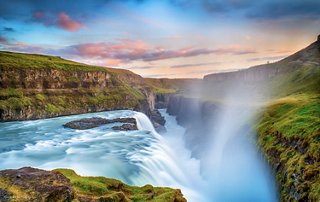 Gullfoss waterfall cascades powerfully under a vibrant sunset sky in Iceland's stunning landscape | MSC Cruises
