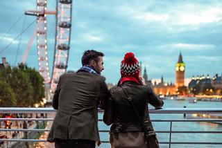 A couple admires the London Eye while enjoying a winter evening in the vibrant city | MSC Cruises