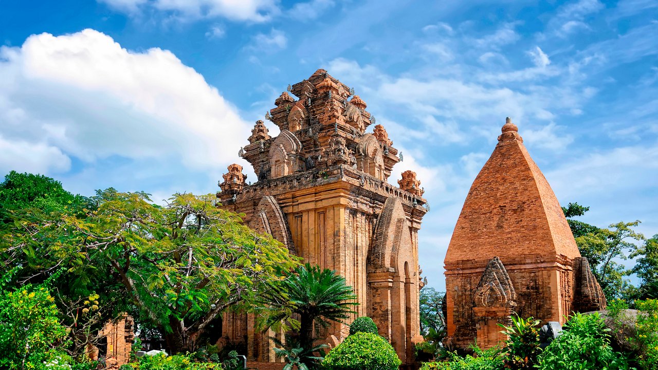 Ancient temples surrounded by lush greenery under a bright blue sky in Nha Trang, Vietnam | MSC Cruises