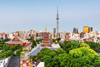 A vibrant Tokyo skyline featuring greenery, modern buildings, and a pagoda against a clear blue sky | MSC Cruises