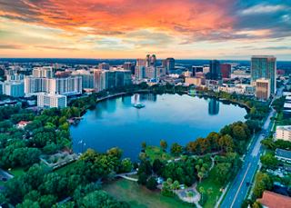 Cityscape of Orlando featuring a lake and surrounding skyscrapers at sunset | MSC Cruises