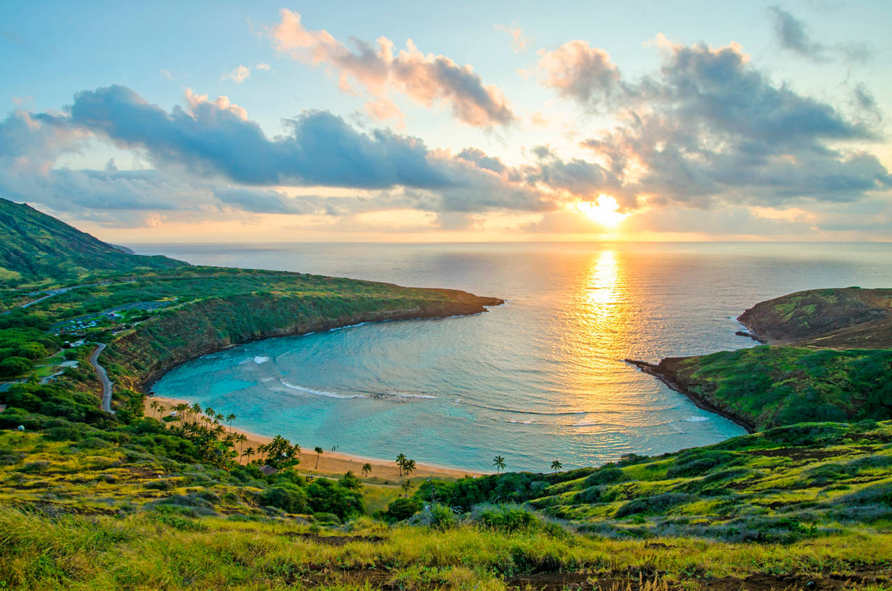 A breathtaking sunrise over Hanauma Bay, highlighting the serene sea and lush vegetation | MSC Cruises