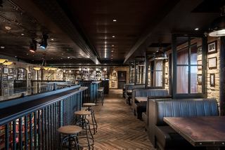 A spacious bar area with seating and a counter, inviting guests to relax and socialise | MSC Cruises