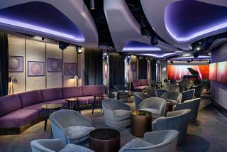 A stylish lounge area featuring comfortable seating and a vibrant atmosphere for socialising and relaxation | MSC Cruises