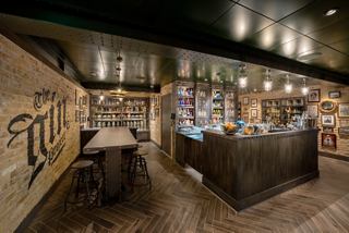 A stylish bar area with a counter, tables, and an inviting atmosphere for socialising | MSC Cruises