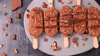 Delicious ice cream bars coated in rich chocolate, sprinkled with almonds, served on a plate | MSC Cruises