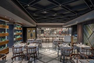 A stylish dining area in the Chef's Garden Kitchen restaurant featuring tables and chairs | MSC Cruises