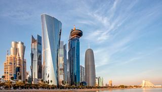 Sunset over Doha's modern skyline in Qatar, illuminating the city in golden hues | MSC Cruises
