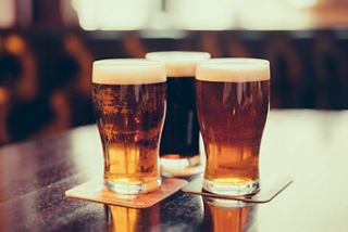 Two chilled glasses of beer sit elegantly on a surface, inviting relaxation and enjoyment onboard | MSC Cruises