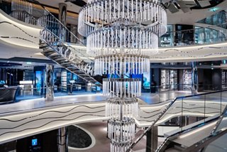 La vibrante Galería Mundial cuenta con un impresionante candelabro y tiendas, invitando a los huéspedes a explorar y disfrutar | MSC Cruceros