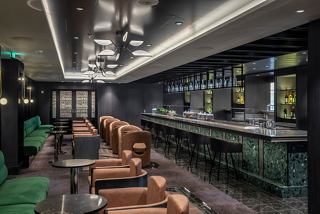 A stylish bar area with seating and a sleek counter, designed for socialising and enjoying drinks | MSC Cruises