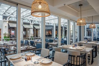 A bright and inviting restaurant setting with tables and chairs ready for guests to enjoy a meal | MSC Cruises