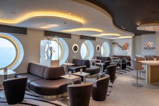 Luxurious seating and porthole views create an inviting atmosphere at Jean-Philippe Chocolat & Café on MSC World Europa | MSC Cruises