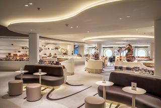A stylish café area featuring elegant seating and sweet displays, inviting guests to enjoy delicious treats | MSC Cruises