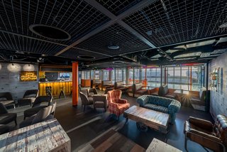 A vibrant bar area featuring a sleek counter, seating, and an inviting atmosphere for relaxation and socialising | MSC Cruises