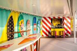 A vibrant bar area with colourful murals and a welcoming counter, inviting guests to enjoy refreshing drinks | MSC Cruises