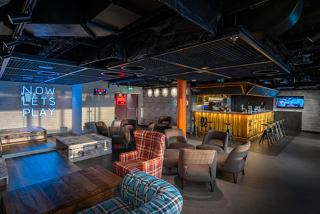 A vibrant bar area featuring stylish seating and modern décor, perfect for relaxing and socialising | MSC Cruises