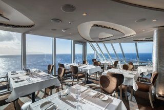 Elegant restaurant with panoramic sea views, inviting guests to enjoy fine dining in the MSC Yacht Club | MSC Cruises