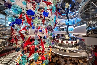 A vibrant interior view showcasing the Incanto del Mare sculpture and MSC Signature Casino aboard MSC Seascape | MSC Cruises