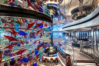 Central area of MSC Seascape featuring colorful glass installations and a modern ambiance | MSC Cruises