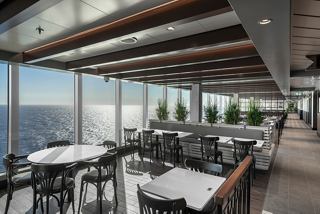 Indoor dining area with sea views and natural sunlight | MSC Cruises
