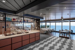 A modern dining area with panoramic windows and a cozy atmosphere | MSC Cruises