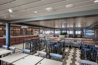 A spacious dining area with tables set for guests, featuring a modern design and inviting atmosphere | MSC Cruises