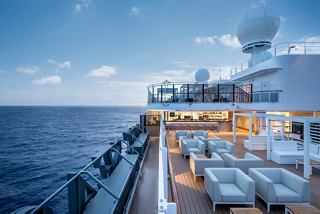 Outdoor bar on MSC Seascape overlooking sea and sky at dusk | MSC Cruises