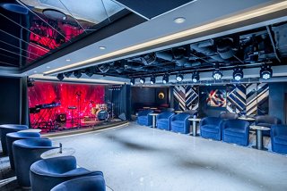 A vibrant lounge area featuring a stage and seating, perfect for entertainment and socialising | MSC Cruises